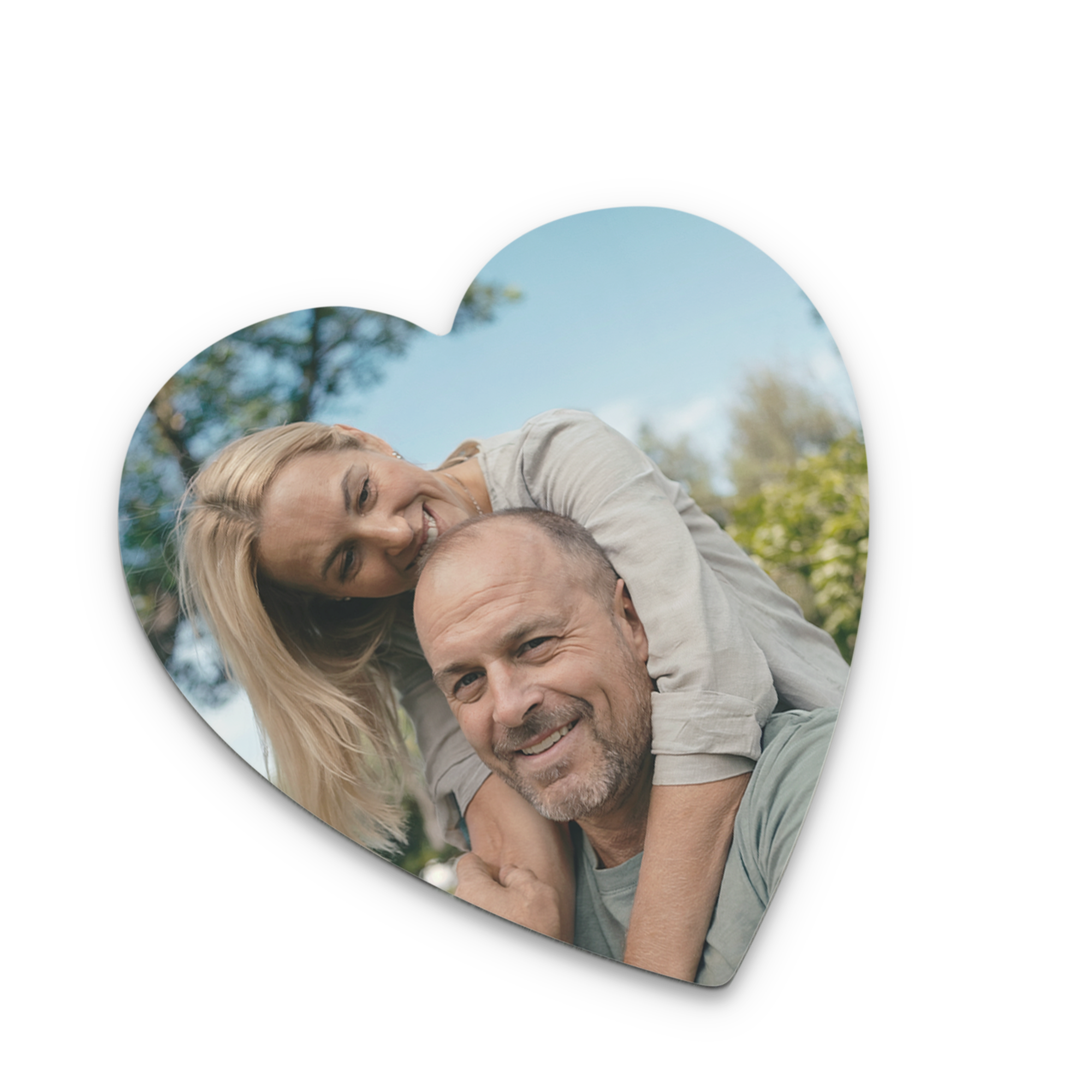 Heart-shaped personalised coaster printed with a photo of a smiling man and woman