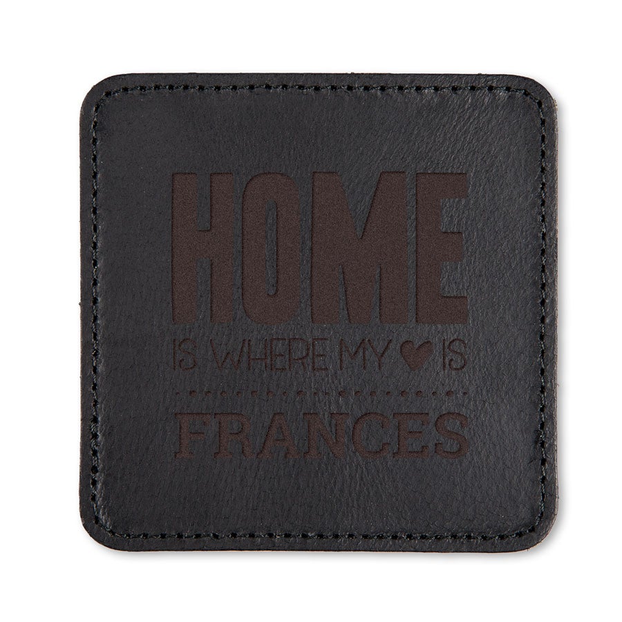 Svart läderunderlägg graverat med texten "HOME IS WHERE MY HEART IS FRANCES"