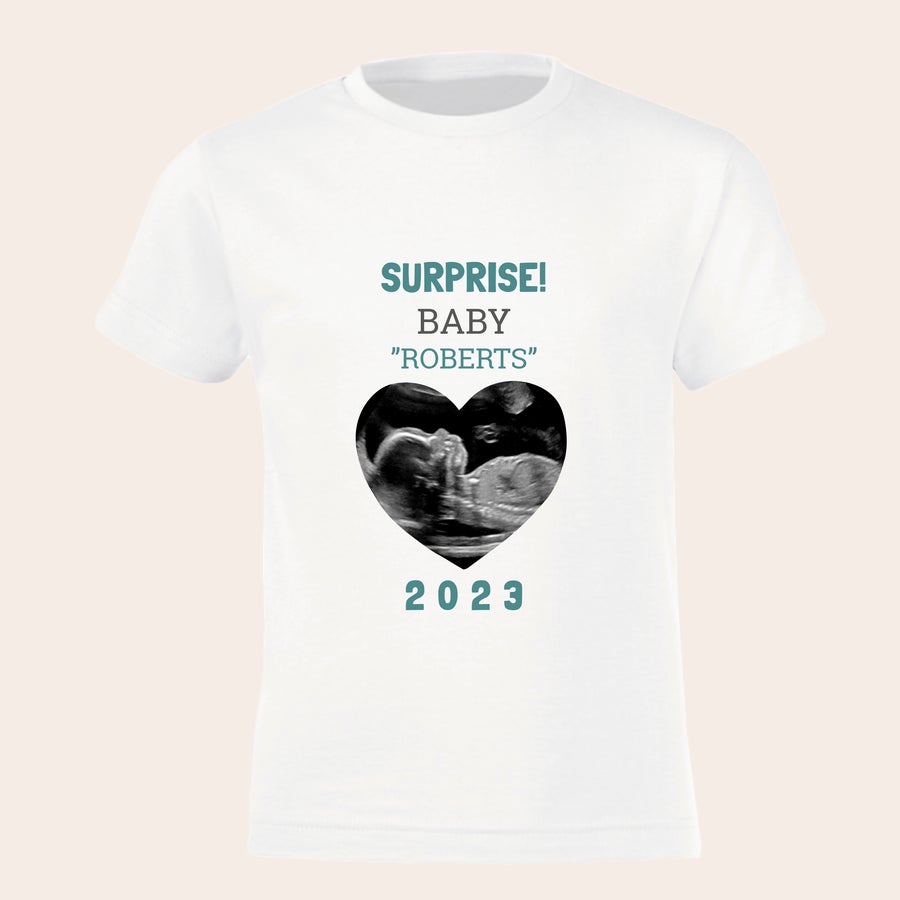 Personalised t-shirt - Big brother / sister White personalized pregnancy announcement t-shirt with printed ultrasound photo inside a heart, custom family name Roberts, and the year 2023