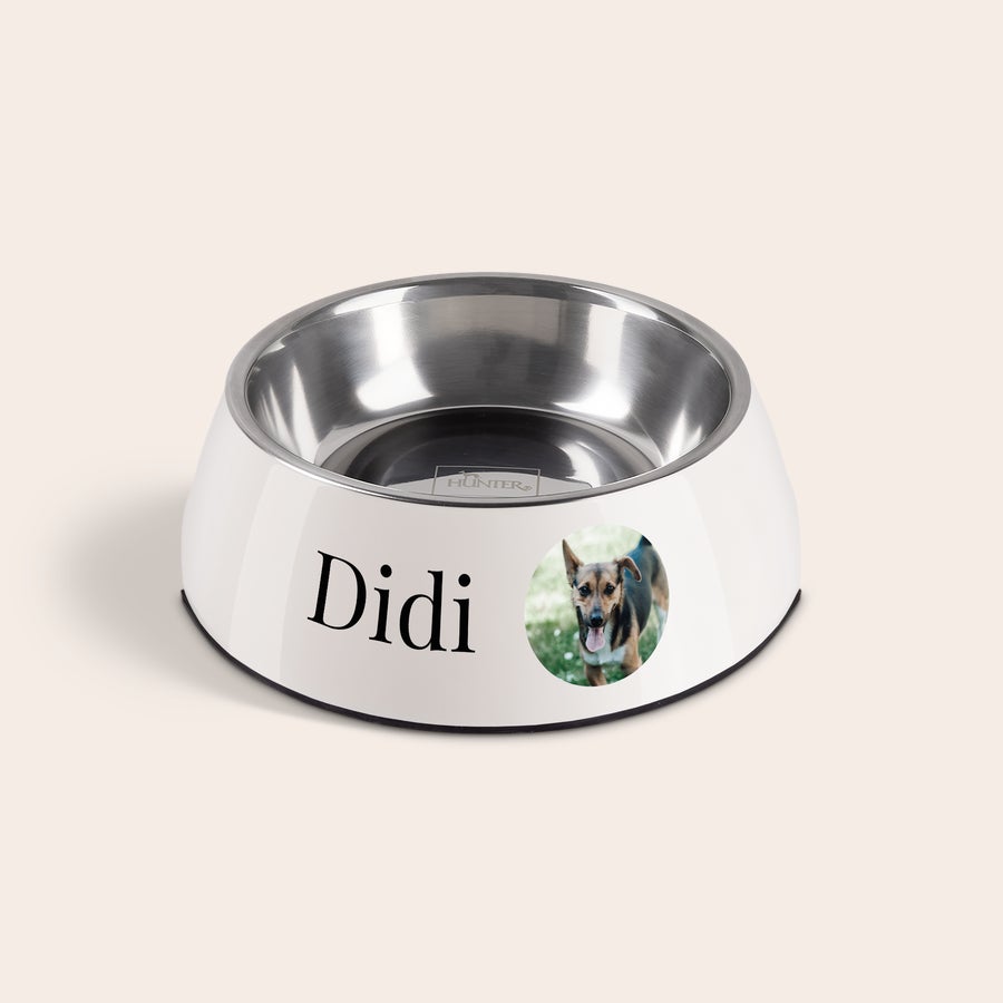 Hundenapf personalisiert Personalisierter Futternapf in Weiß mit dem Namen Didi und einem Foto des Hundes, der spielerisch aus dem Gras schaut, bedruckt.