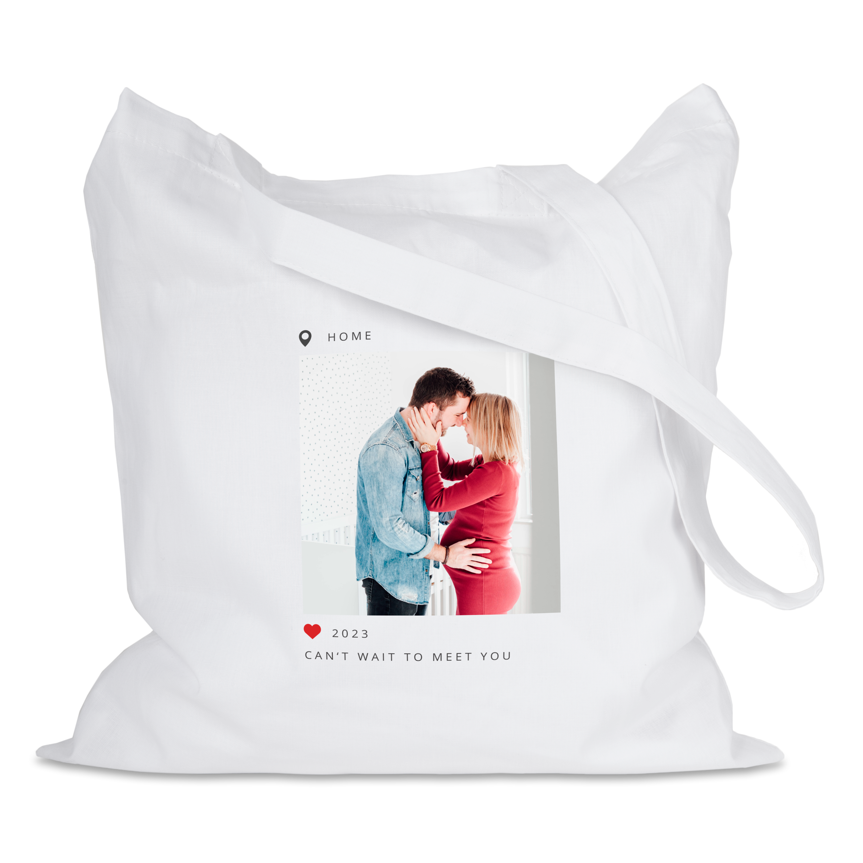White printed tote bag with a custom photo of a couple and the text CAN'T WAIT TO MEET YOU.