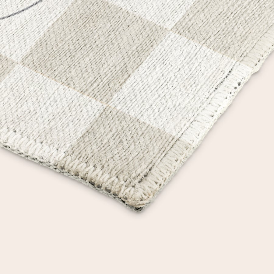 Printed Play Mat Close up of a personalized play mat with a checkered pattern in light gray and white fabric