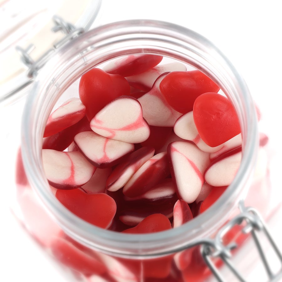 Personalised sweet jar Open glass jar filled with red and white heart shaped personalised sweet jar candies