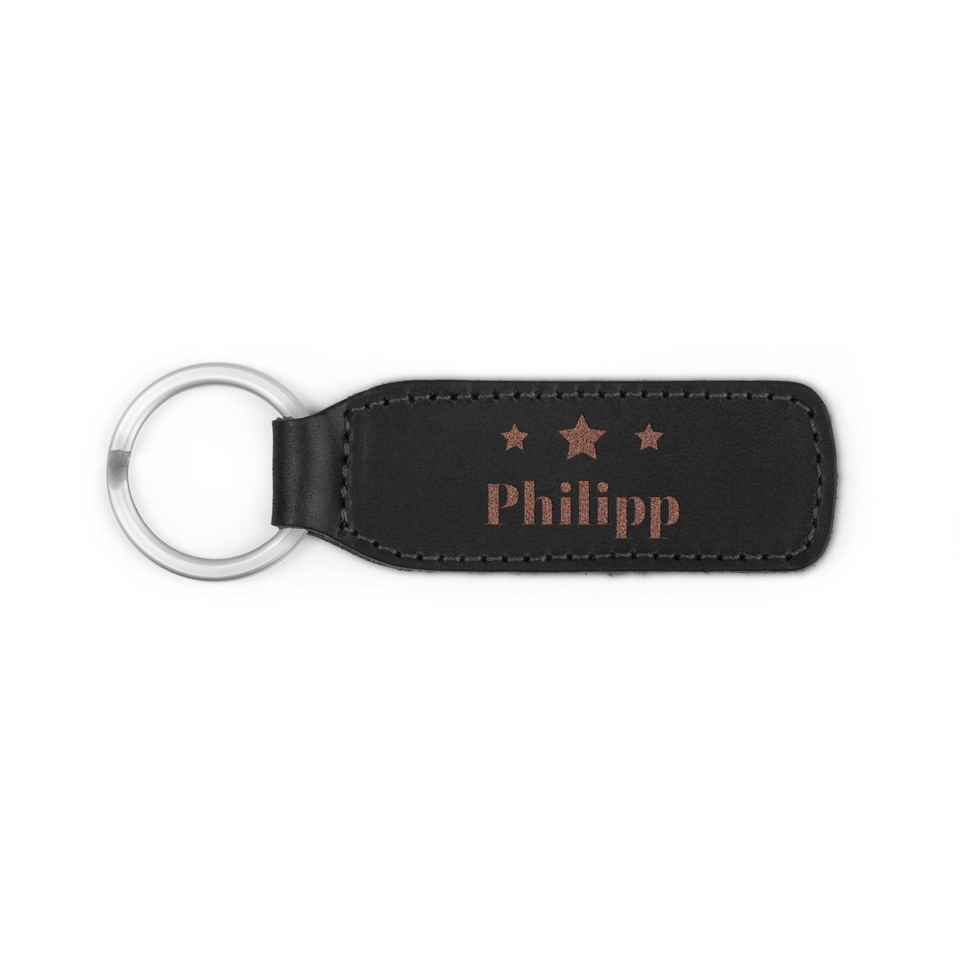 Ein personalisierter Schlüsselanhänger aus schwarzem Leder, graviert mit dem Namen Philipp und Sternen.