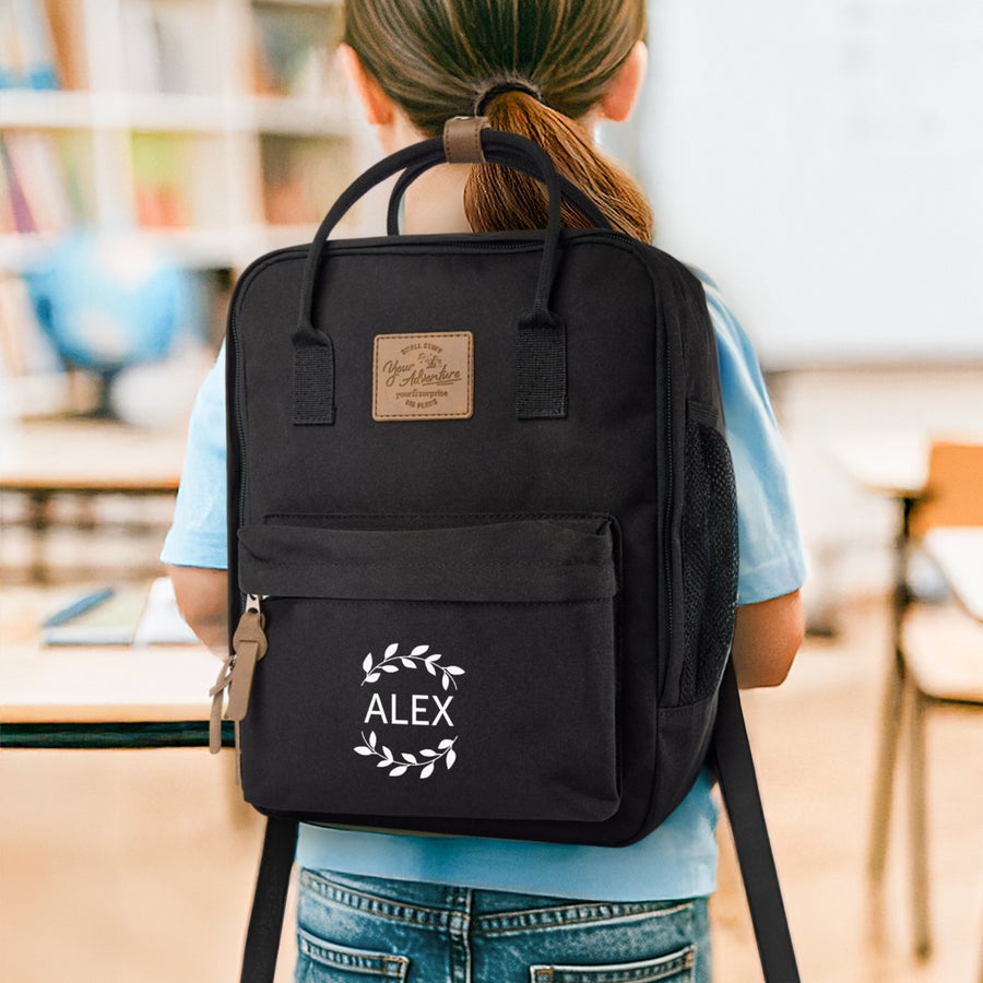 Personalised backpack - Children Black personalized children's backpack printed with the name Alex surrounded by a white laurel wreath design