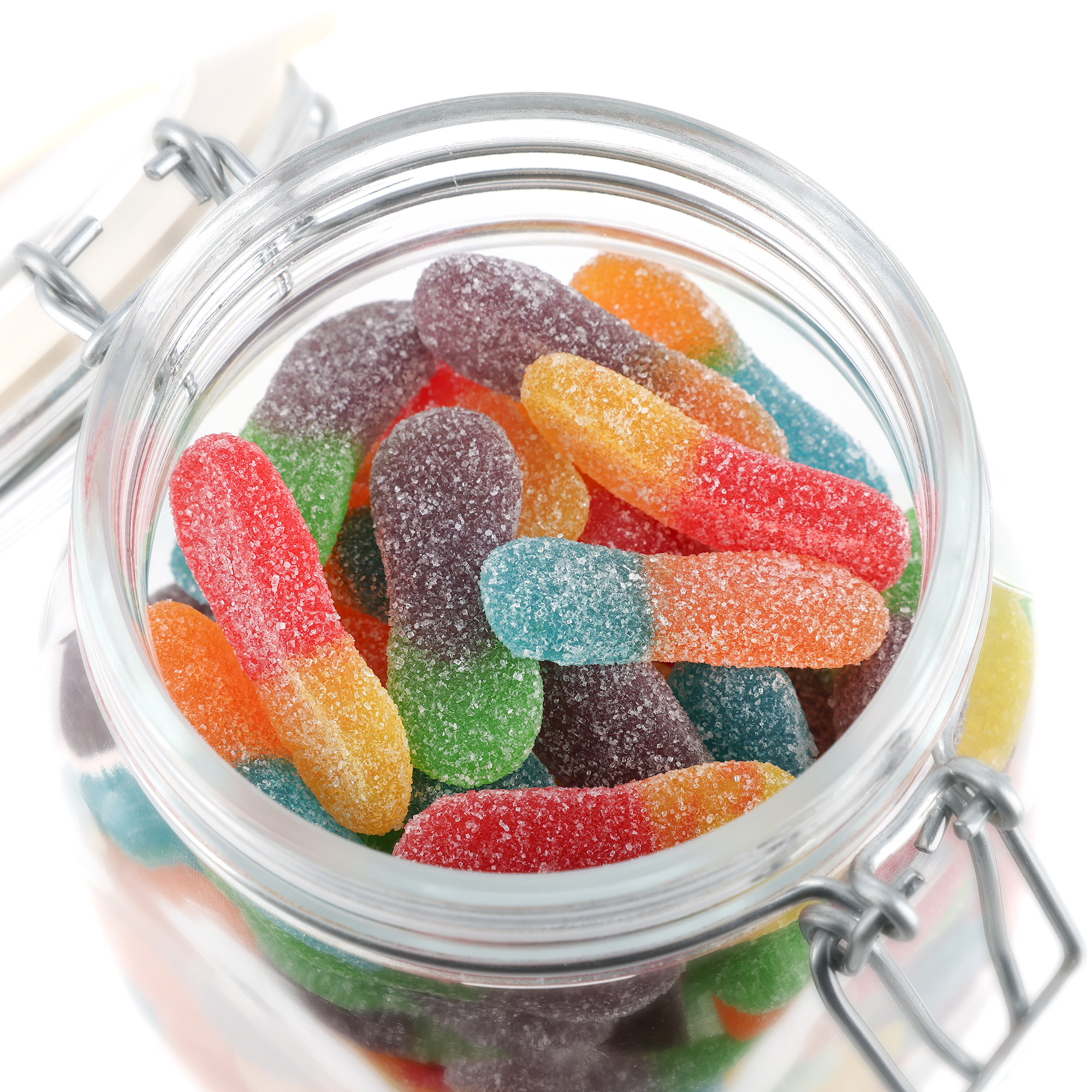Bocal à bonbons personnalisé avec des bâtonnets acidulés de différentes couleurs, rempli à ras bord, vue du dessus