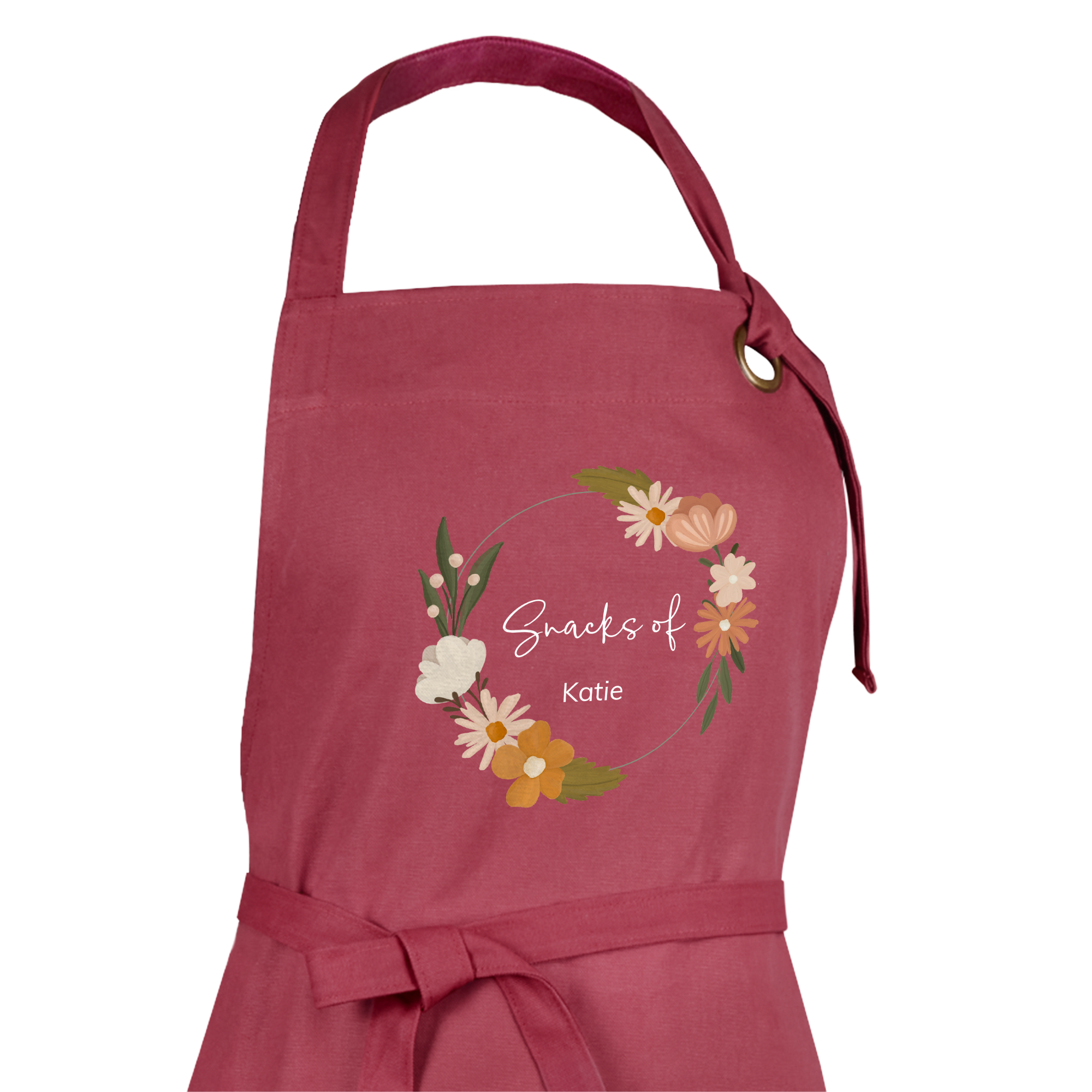Personalized apron in dark pink with a custom floral design and "Snacks of Katie" text.