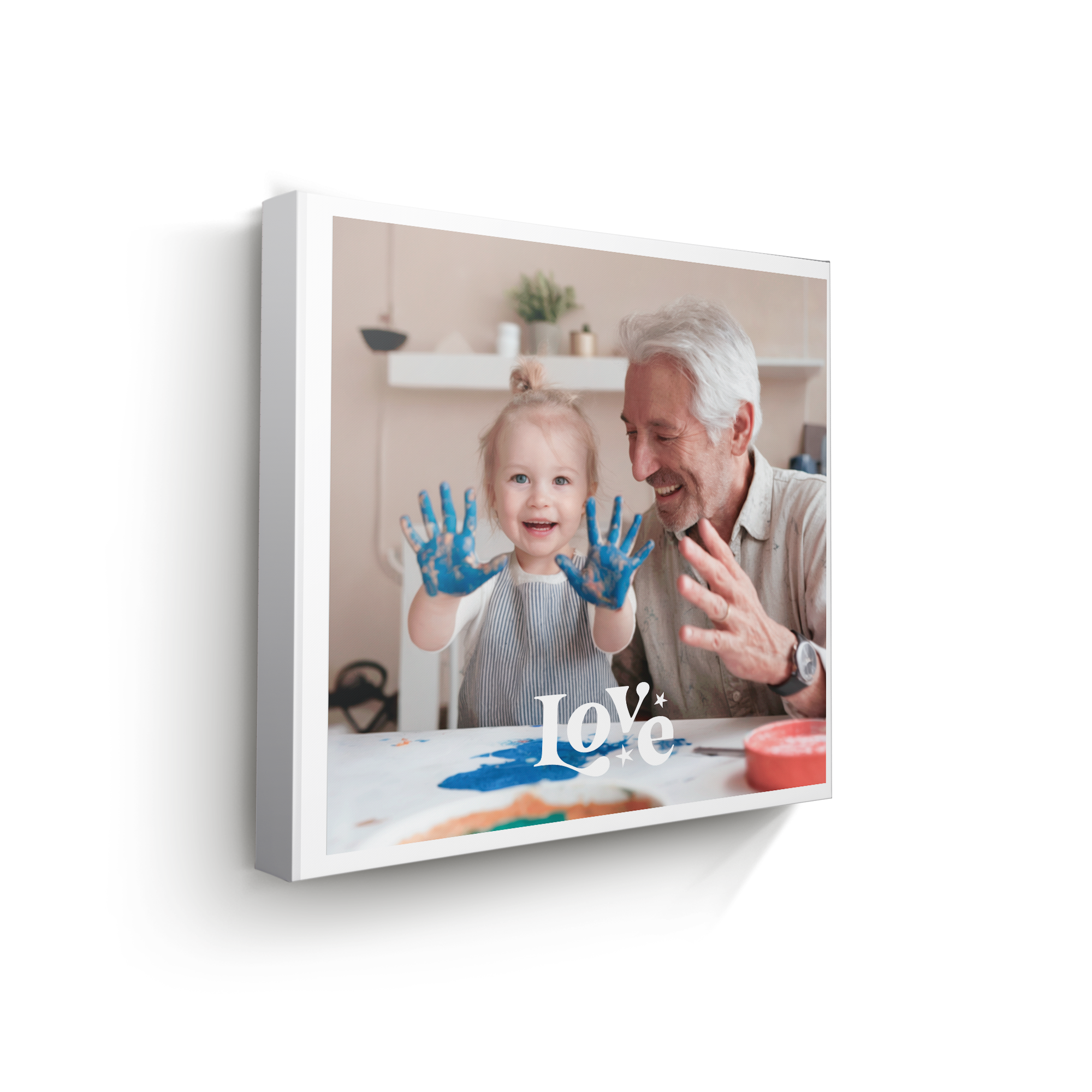 Personalized photo canvas with a printed photo of a child and grandfather painting, featuring the word Love. Have your favourite photos printed on high-quality canvas.