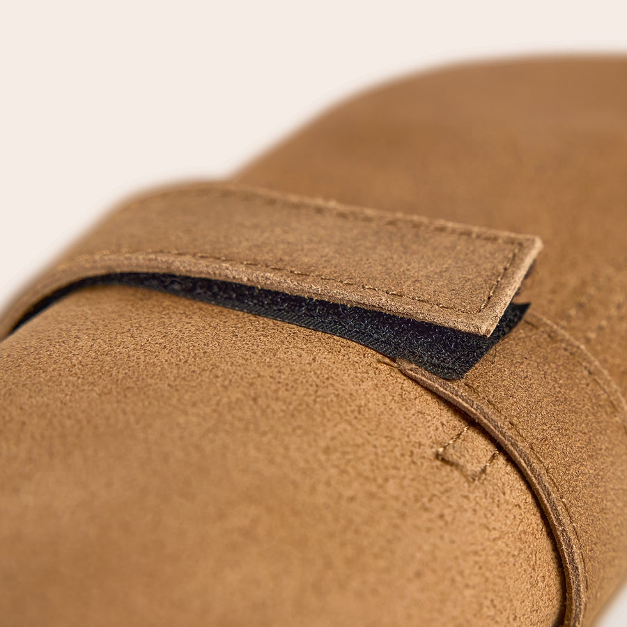 BBQ set in leather cover with name Close-up of the brown leather case for a personalized barbecue set, showing a velcro strap