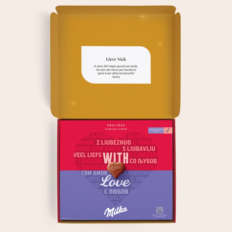 Milka Pralines Kerst Geopende gepersonaliseerde Milka geschenkdoos met hazelnoot-crème pralines. De doos is geprint met een kerstboodschap voor 'Nick' van 'Sanne'.