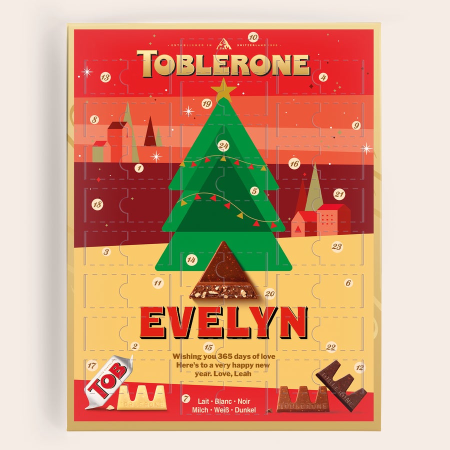 Personalizovaný adventní kalendář - Toblerone 2025 Personalizovaný adventní kalendář Toblerone se jménem Evelyn a vzkazem, potištěný vánoční grafikou.