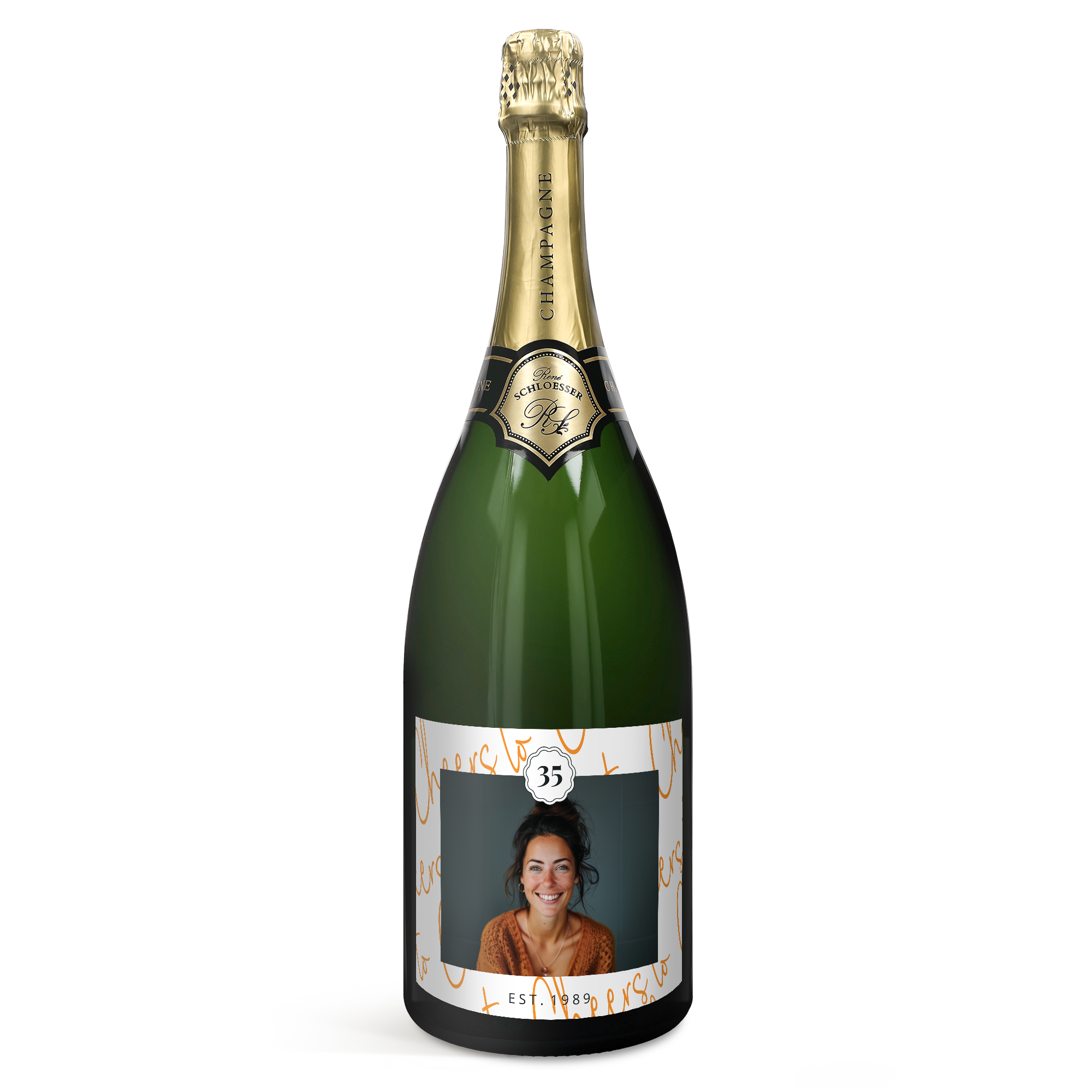 Green bottle of René Schloesser champagne with a personalized label featuring a smiling woman a 35 and "Est. 1989"