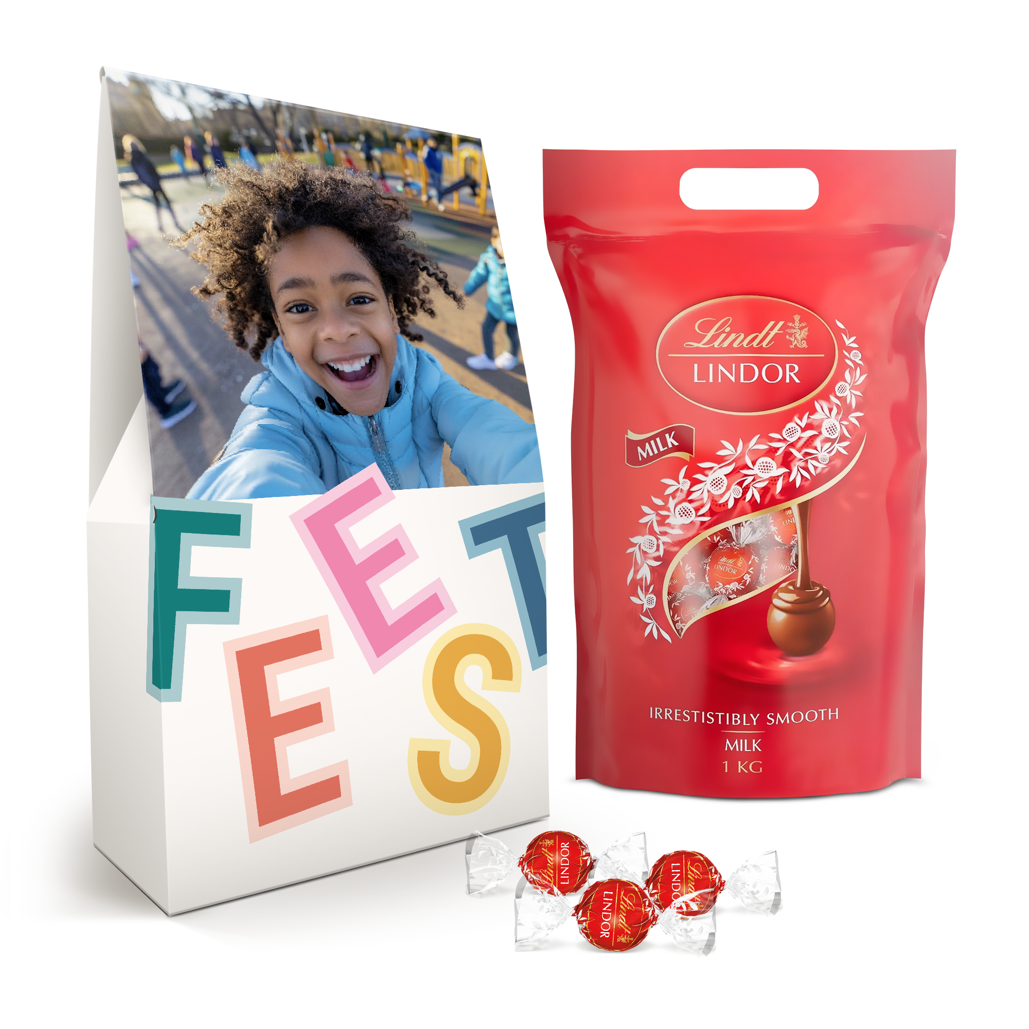 Witte giftbox met foto en tekst “FEEST”, met daarnaast een zak van 1 kilo Lindor melkchocoladebonbons.