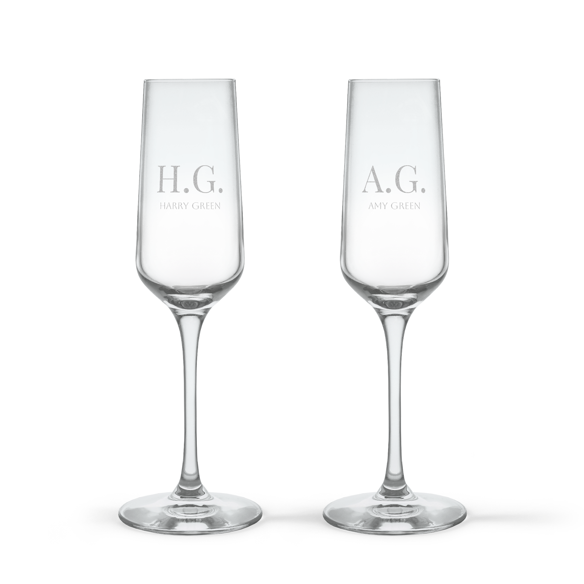Two personalised crystal champagne glasses, one engraved with H.G. Harry Green and the other A.G. Amy Green