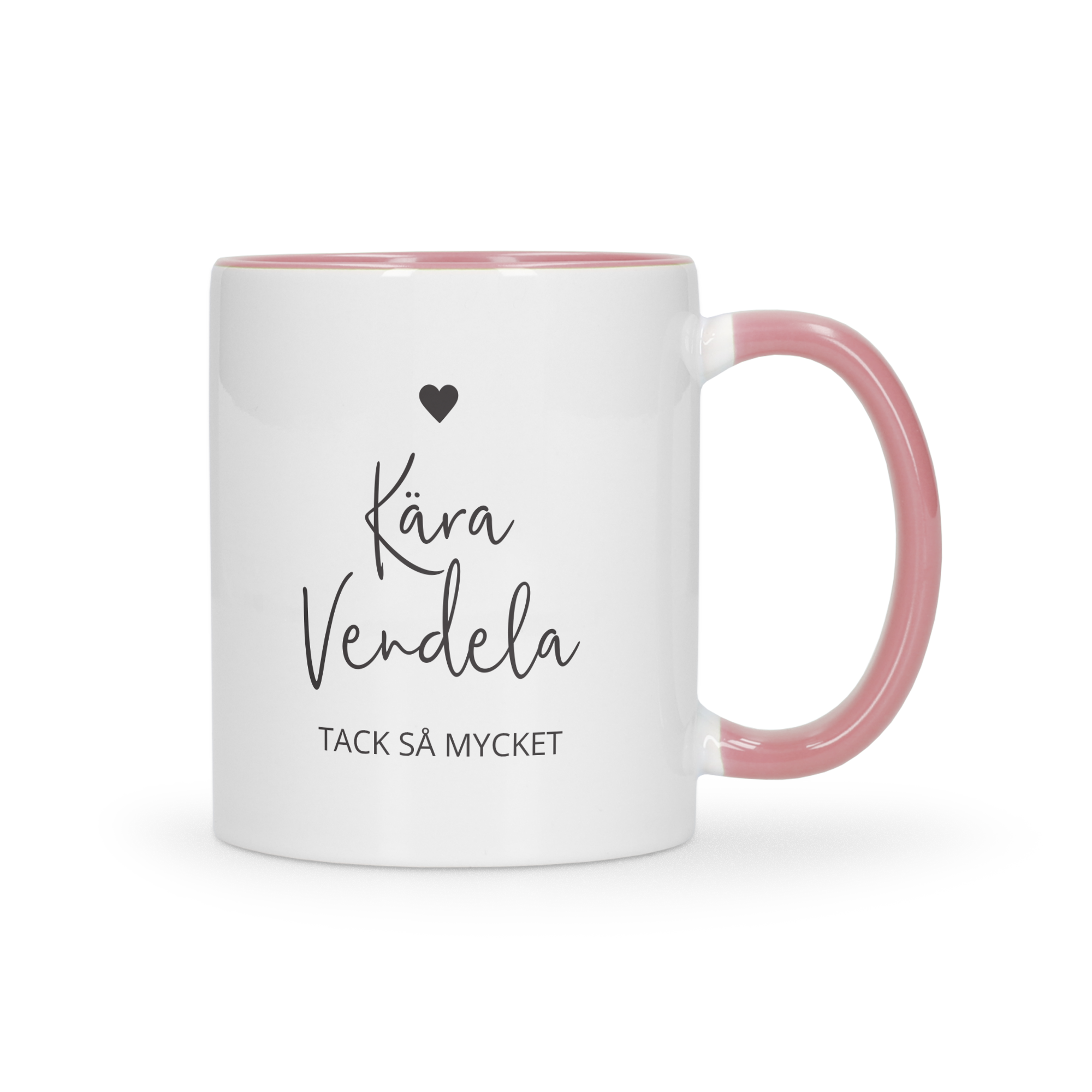 Vit mugg med rosa insida och handtag, tryckt med en svart text Kära Vendela Tack så mycket. Ge en färgglad mugg som en gåva!