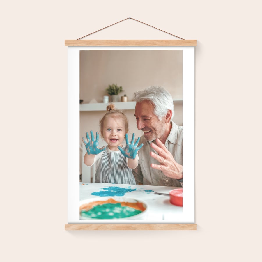 Personalised poster with hanger Personalized photo poster with a magnetic poster hanger showing a child and adult with painted hands