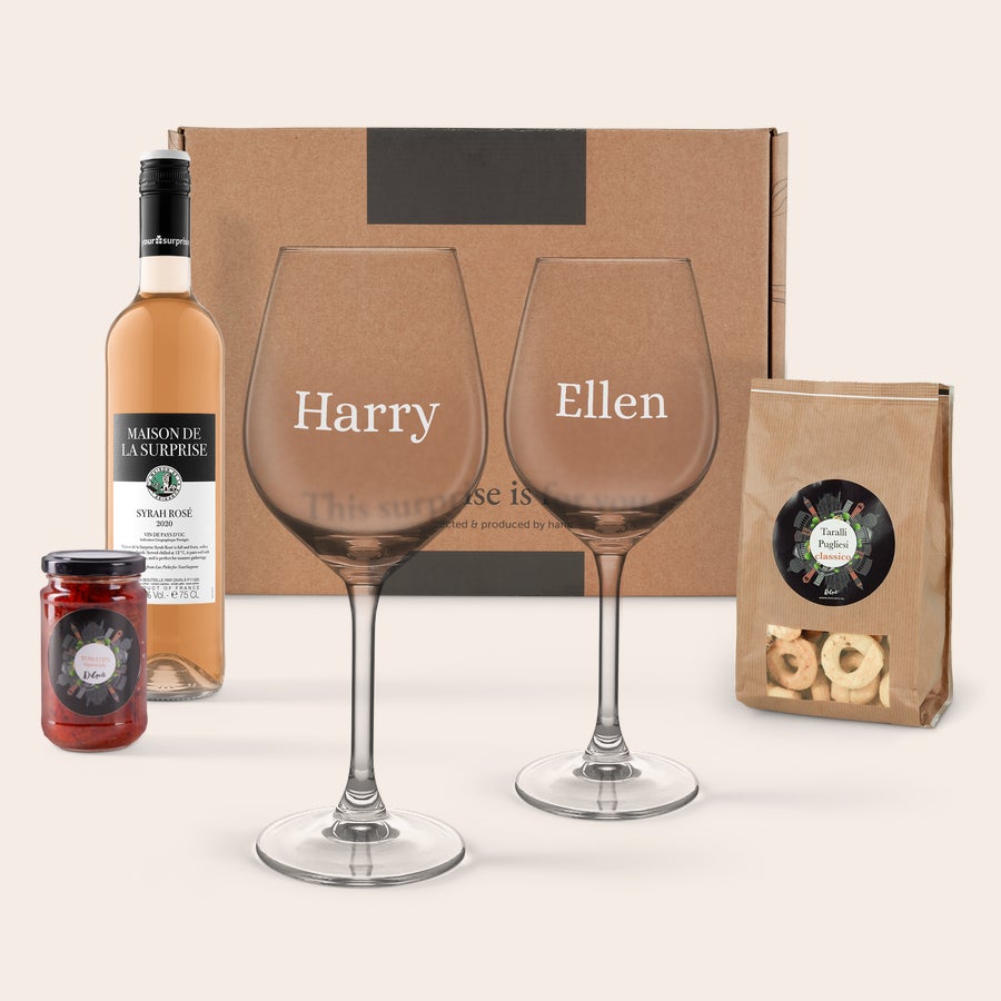 Personalised wine & snacks gift set Personalized wine and snacks gift set with two wine glasses engraved with "Harry" and "Ellen", rosé wine, tapenade, and crackers.