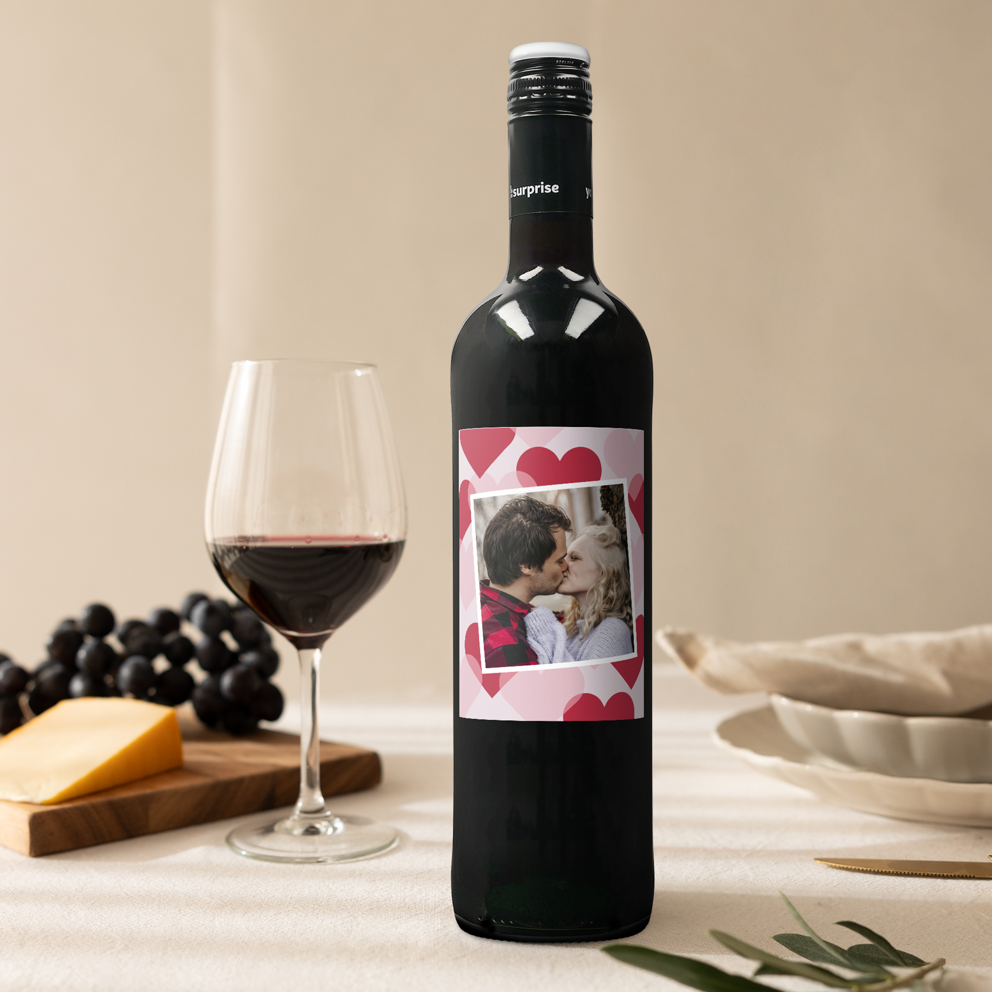 Maison de la Surprise Merlot with a personalized label, printed with a photo of a couple kissing, against a heart-patterned background, for your loved ones