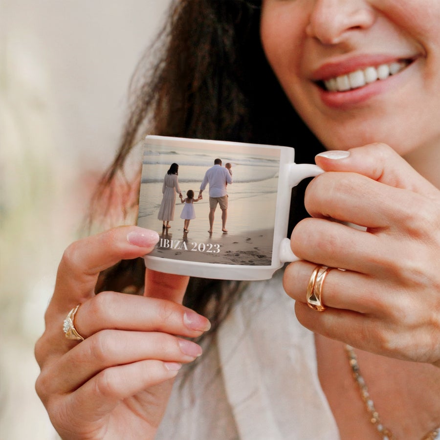 Stackable mugs with photo Woman holding a white custom stackable photo mug printed with a family photo from IBIZA 2023.