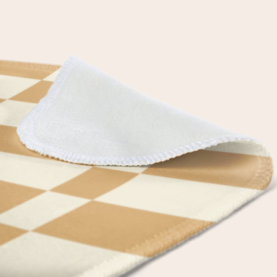 Personalised photo blanket Close up of a fleece photo blanket with an unprinted white underside and a light brown and cream checkerboard pattern on top