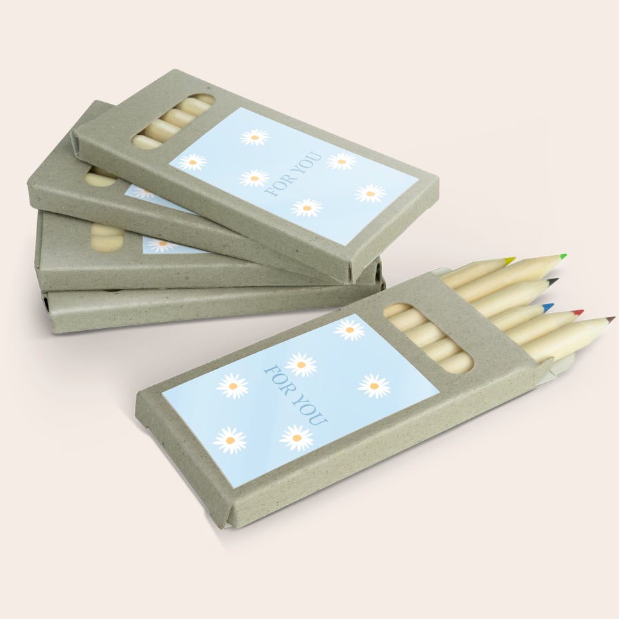 Colouring pencils Several personalized colouring pencils in their cardboard boxes, printed with a daisy design and the text FOR YOU, are arranged together. These colouring pencils make fantastic favours.